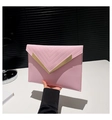Detail of pink envelope clutch featuring chevron quilting and gold V-shaped metal trim - Pink