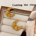 Close-up of French vintage gold-plated C-shaped spiral wrap stud earrings in a jewelry box - Gold Earrings - Real Gold Plated Copper