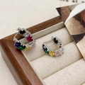 Macro shot of silver C-shaped hoop earrings with vibrant colorful cubic zirconia inlay - Multi-Color Zirconia Earrings - Gold Plated Copper