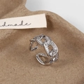 Macro detail of silver hollow geometric ring with cubic zirconia on textured background - Silver