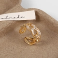 Macro detail of gold-plated hollow chain ring with baguette zircon stones - Gold