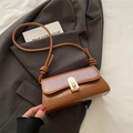 Brown glossy leather crossbody bag with gold twist lock and stylish knotted shoulder strap - Brown