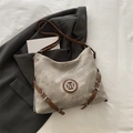 Gray canvas and brown leather crossbody bag with vintage M logo on a gray blazer - Khaki