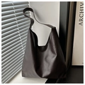 Close-up of deep brown tote bag with premium lychee texture and soft hobo style - Coffee