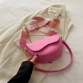 Bolso de montura rosa con correa ancha y herrajes dorados sobre traje beige - Rosa