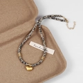 Makroaufnahme von Natursteinperlen und goldenem Herzanhänger an handgefertigter Kette - Gold Herz Anhänger Dalmatiner Jaspis Halskette