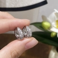 Close-up of silver micro-paved zircon hoop earrings with a secure snap closure - Silver Large