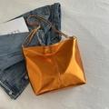Metallic orange shoulder bag with golden chain strap and shiny faux leather finish - Orange