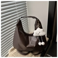 Detail of dark brown leather hobo bag with logo embossing and cute plush charm - With Pendant / Brown