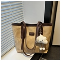 Detail view of khaki canvas tote with brown leather trim and cloud plush charm - With Pendant / Khaki