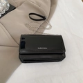 Glossy black patent leather crossbody bag with silver chain strap and flap closure - Black