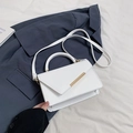 White lychee grain leather crossbody bag with asymmetric flap and golden metal detail - White