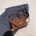 Brown vintage leather crossbody bag with metallic gold bar and adjustable strap - Brown