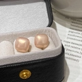 Square pearl stud earrings in champagne pink pearl finish displayed in a black jewelry box - Champagne