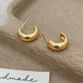 Detail of chunky gold C-shaped hoop earrings showing S925 hallmark on a brown display tray - Gold Polished C-Shape Earrings (A-934)