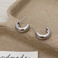 Macro detail of silver C-shaped stud earrings with high-polish metallic finish - Silver Polished C-Shape Earrings (A-934)