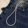 Detail der weißen Muschel-Perlenkette auf Denim mit verstellbarem Silberverschluss - 3mm Muschelhalskette