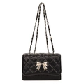 Elegant black quilted crossbody bag with silver bow clasp and woven chain strap - Black