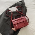 Burgundy faux leather square handbag with heart buckle, bow details, and adjustable strap - Red