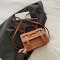 Brown leather satchel bag with heart bow and silver studs in a crossbody style - Brown