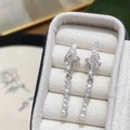 Close-up of geometric spiral earrings with micro-set zircons and pearl tassels - Silver Micro-Inlaid Zirconia Pearl Earrings