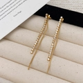 Elegant gold-tone long tassel drop earrings with sparkling cubic zirconia on velvet tray - Gold Zirconia Tassel Stud Earrings