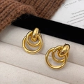 Polished gold geometric triple hoop earrings displayed on a white jewelry tray - Gold