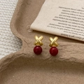 Retro gold-plated cross earrings with dark red faux pearls on a minimalist background - Matte Gold Red Pearl