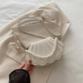 Elegant cream shell-shaped crossbody bag with quilted texture and faux pearl handle - Off White