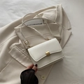Elegant white square crossbody baguette bag with gold metal lock on beige blazer - White