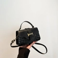 Chic black crossbody bag featuring smooth texture and faux crocodile skin pattern - Black