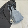 Light blue nylon mini backpack with a white plush monster charm and adjustable strap - With Pendant / Blue