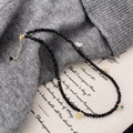 Elegant beaded necklace with black crystals and white flower charms on a sweater background - Black Crystal Flower Style (B-481-黑水晶)