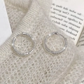 Detailed view of silver micro-pave hoop earrings with cubic zirconia on soft knit background - Silver Geometric Zircon Earrings