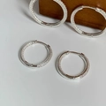Macro detail of silver pavé hoop earrings featuring micro-set cubic zirconia crystals - Silver Small Zirconia Earrings