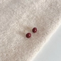Minimalist deep red pearl stud earrings on a beige knit texture background - 10mm Red Ball