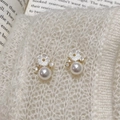 Detailed close-up of pearl flower earrings with crystals on a soft knit background - Gold Flower Pearl Earrings / 0.1