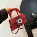 Glossy red crocodile embossed handbag featuring a large crystal buckle and ruched handle - Red