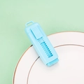 Light blue retractable mini box cutter with sliding mechanism on a white ceramic plate - Blue
