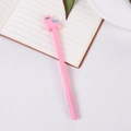 Pink alpaca gel pen with cute 3D soft rubber figure on a notebook background - Pink