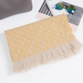 Plaid knitted scarf in yellow and beige with fringe tassels on white texture background - Yellow