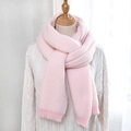 Detailed view of pink herringbone knit scarf texture with ribbed edges on a mannequin - Pink