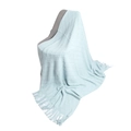 Light blue knit throw blanket with diamond pattern and fringe on a grey chair - Light Blue