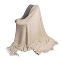 Beige knitted throw blanket with diamond pattern and decorative tassels on a chair - Khaki