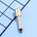 Macro shot of 6.7g gold grenade-shaped pen featuring RF logo on blue background - Gold