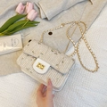 White woven straw crossbody bag with green floral embroidery and gold chain strap - Off White