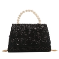 Black sequin handbag with white pearl handle and gold chain strap on white background - Black
