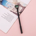 Cute black monster gel pen with green eyes and white teeth on pink background - Green-Eyed Little Devil / 0.5mm