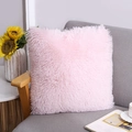 Soft light pink faux fur square decorative pillow on a modern grey sofa in a bright home - Pink