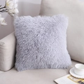 Light grey long faux fur throw pillow cover on a modern beige sofa setting - Gray